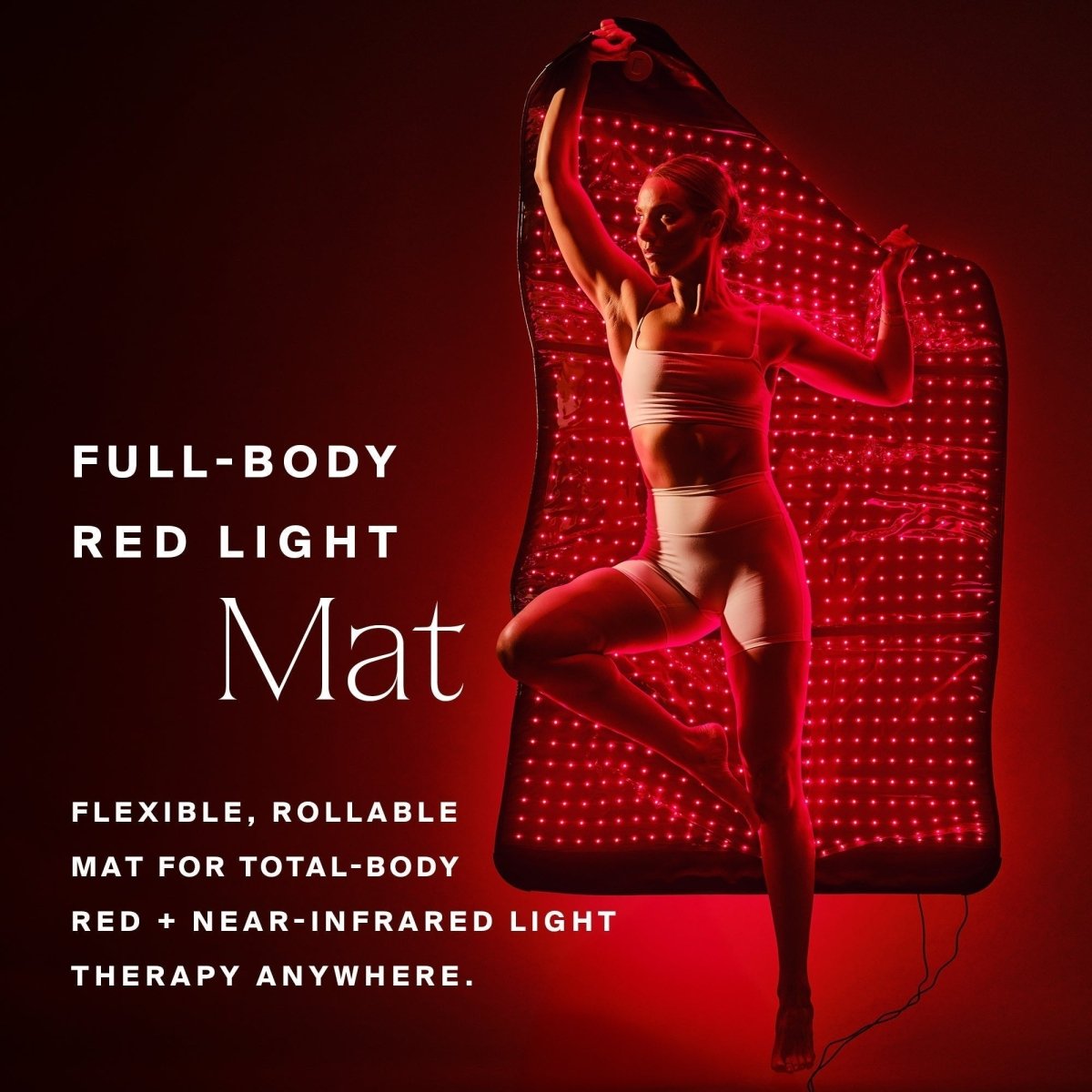 Woman posing in front of the HigherDOSE Full Body Red Light Mat glowing red: flexible, rollable mat for total-body red light
