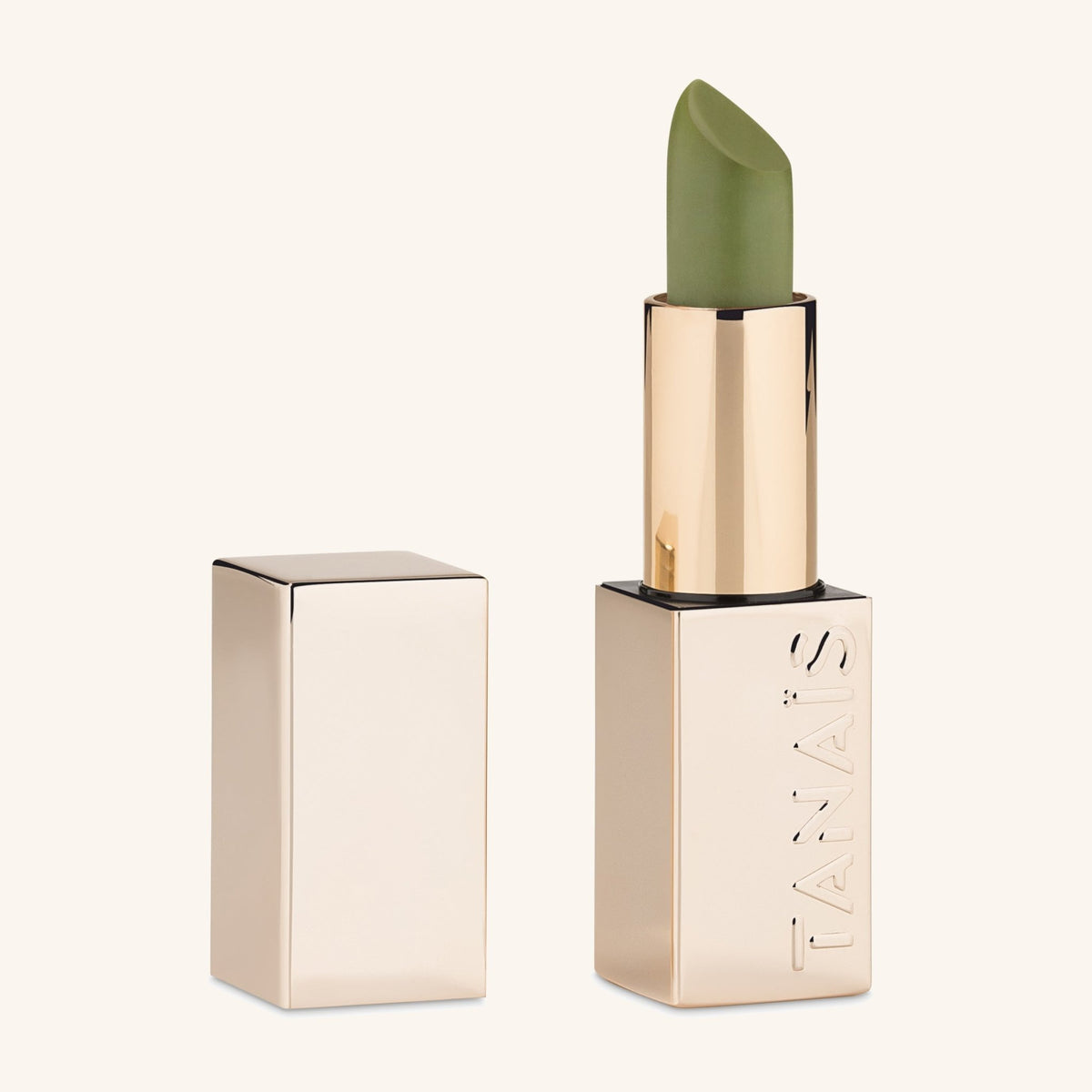 TANAÏS Heart Chakra Mood Change Lip Stain in green with a gold case that turns pink on the lips
