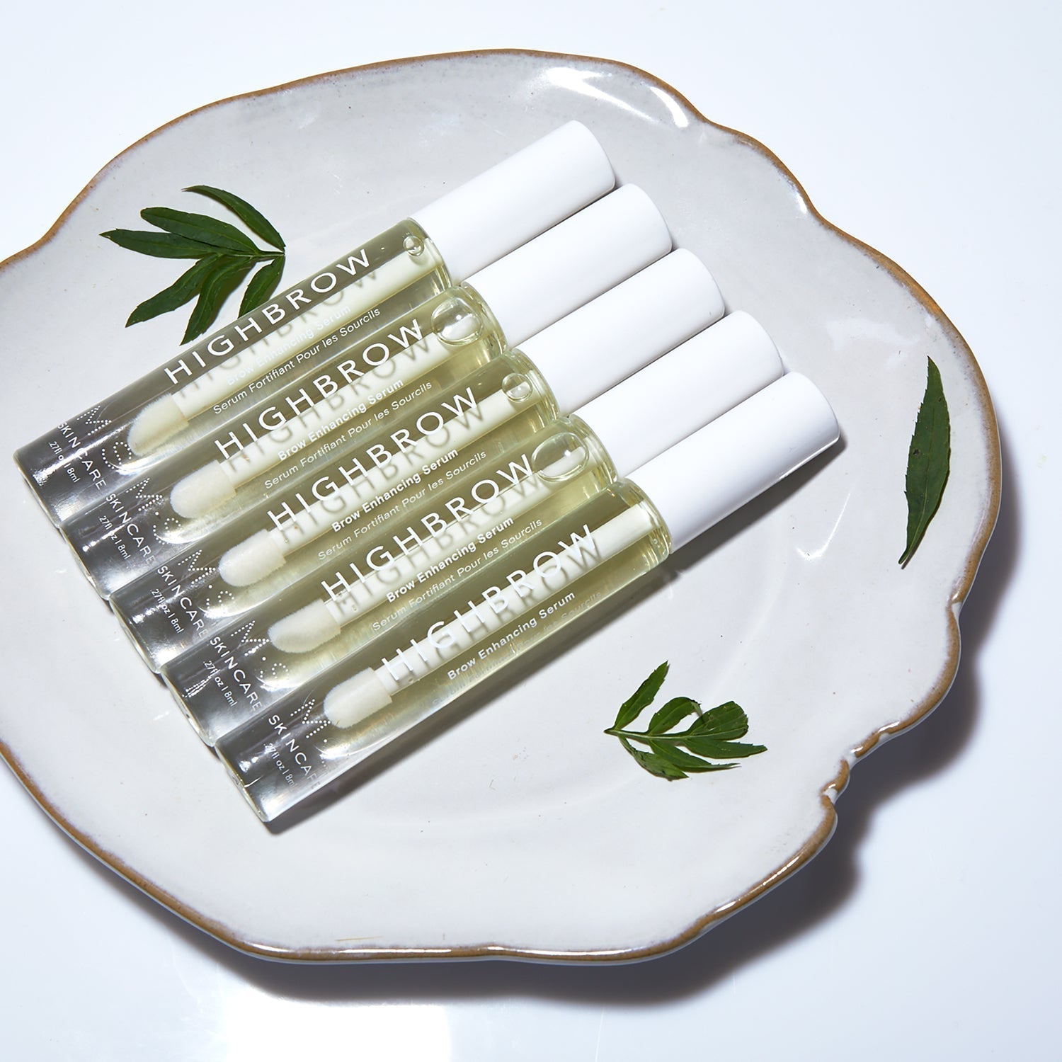 HIGHBROW by M.S. Skincare brow serum in glass bottle with white applicator wand