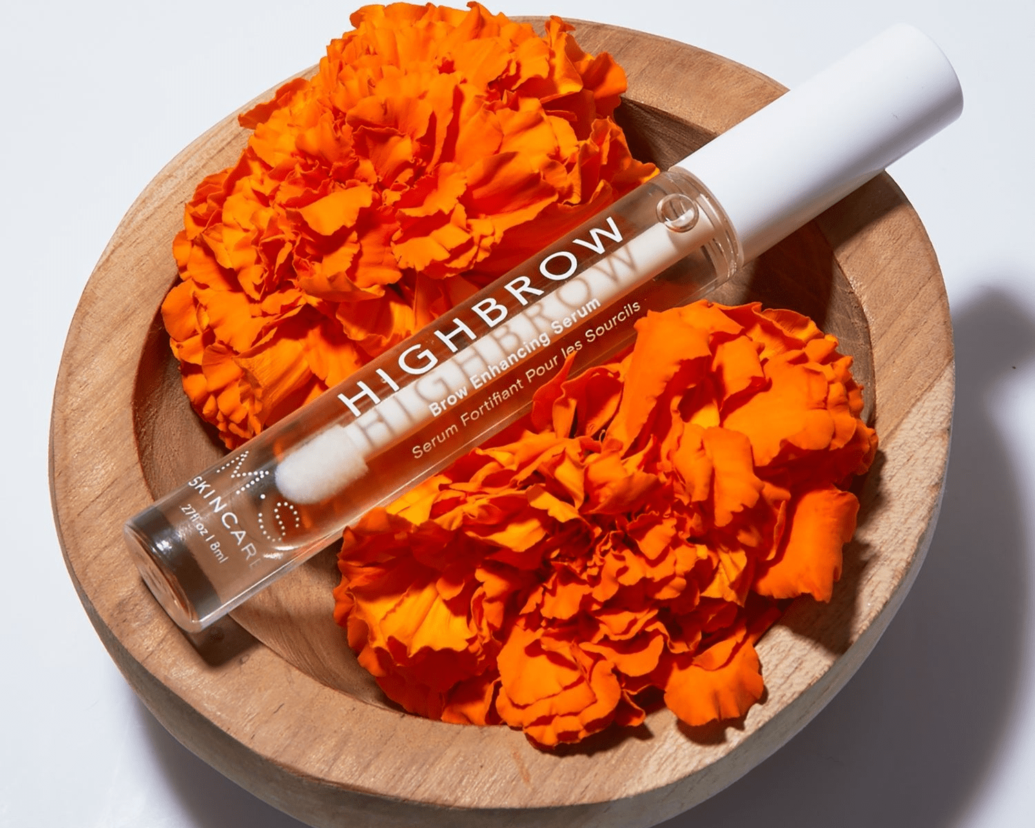 HIGHBROW by M.S. Skincare brow serum in glass bottle with white applicator wand