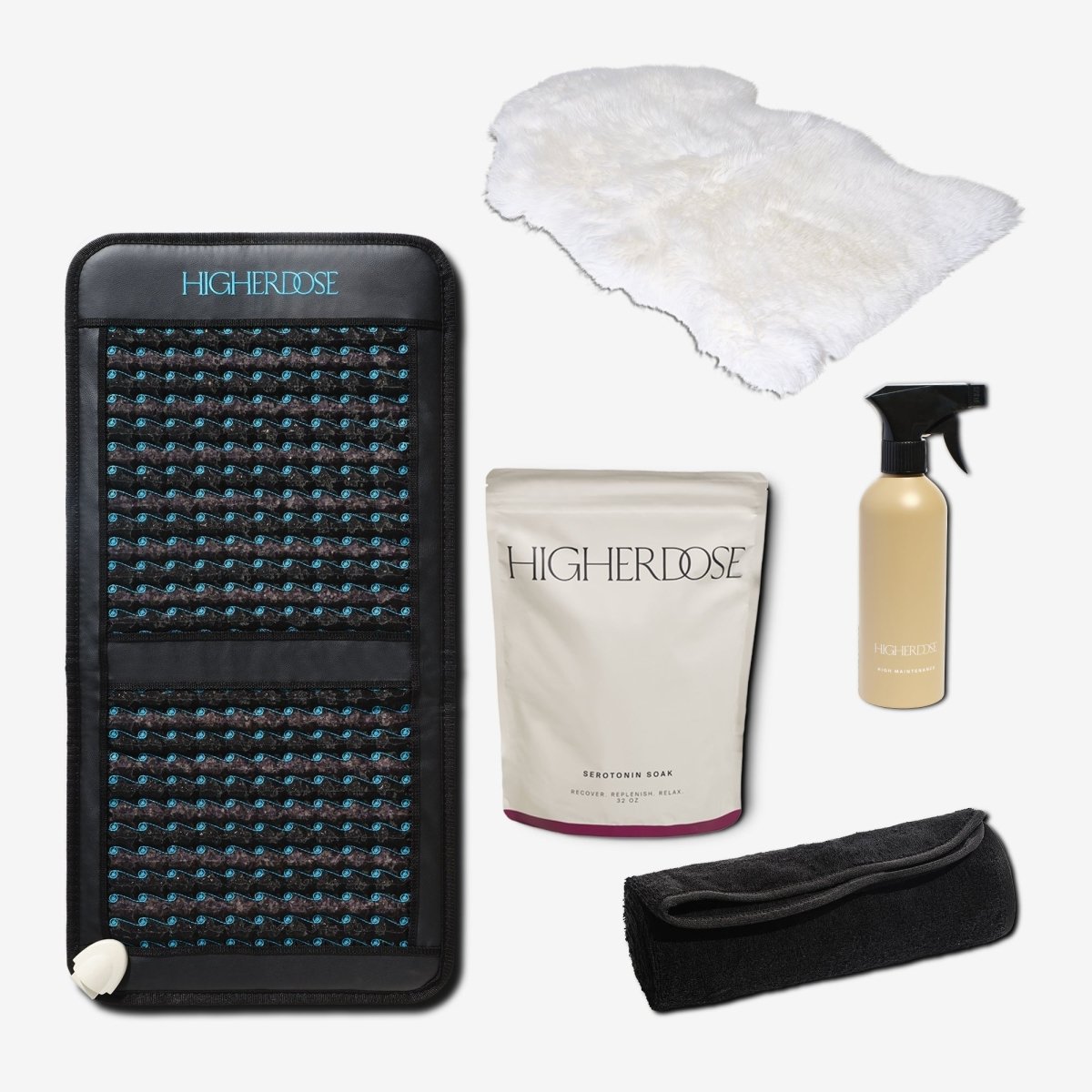 HigherDOSE Infrared PEMF Go Mat with its Serotonin Soak, cleaner, sheepskin cover and towel topper on white