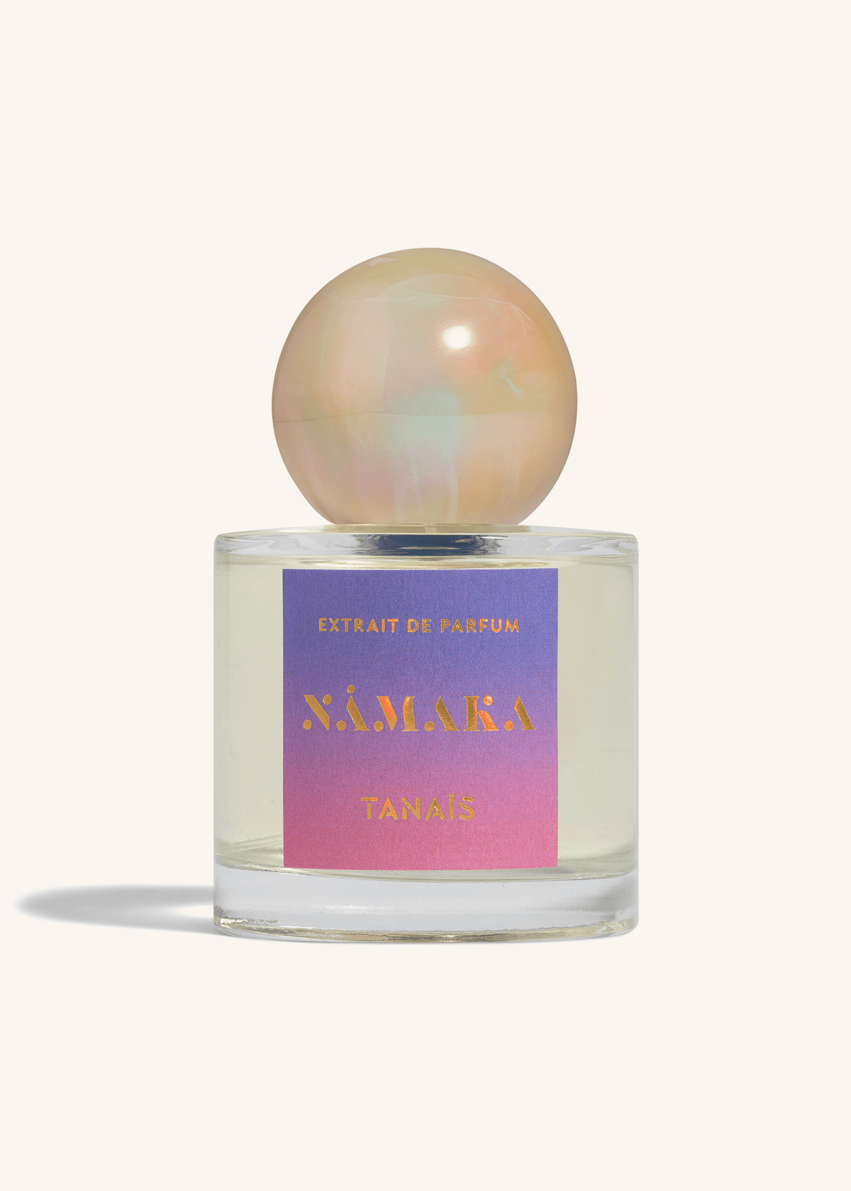 TANAÏS Nāmaka Extrait de Parfum bottle with a blue-to-pink gradient label and pearl cap, front view