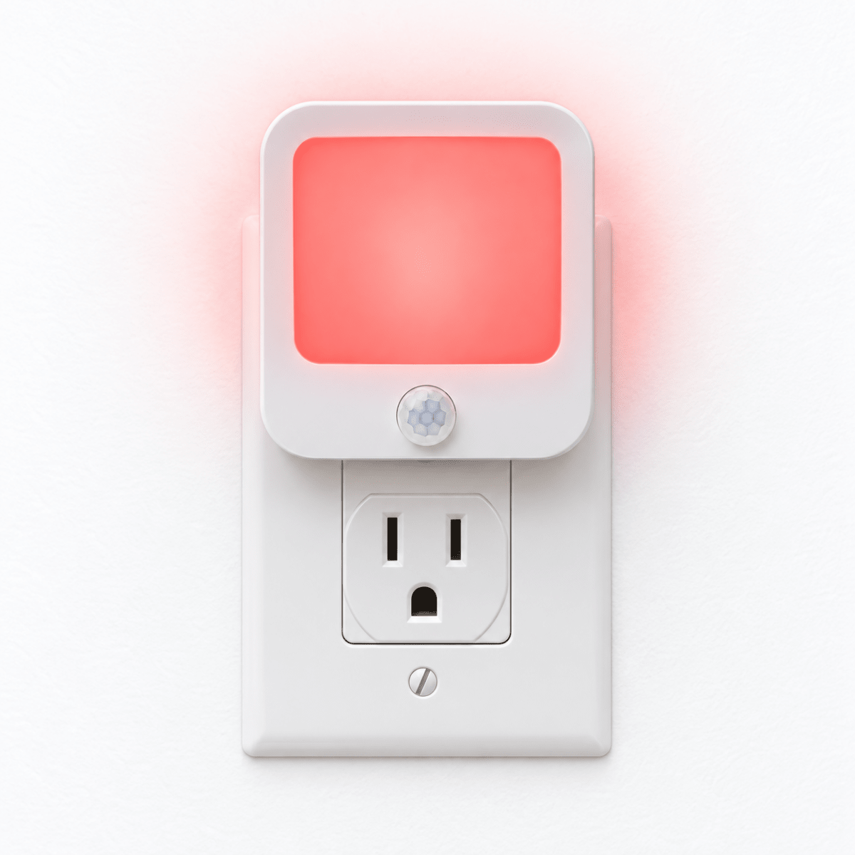 DreamWalkerz red nightlight glowing in a wall outlet on a white wall