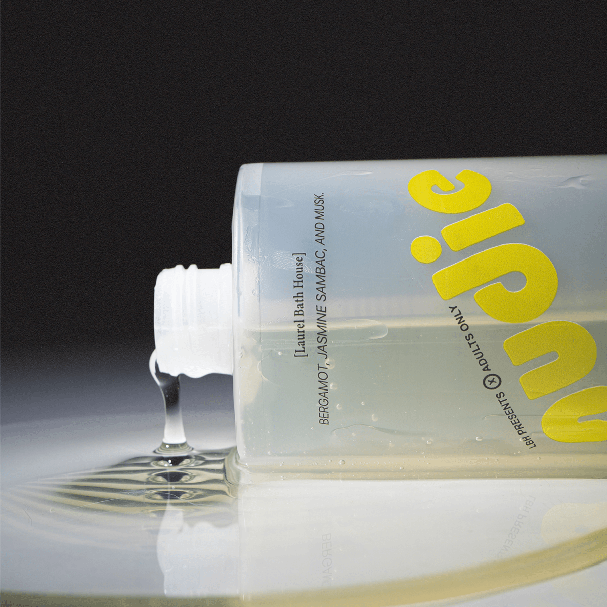 Laurel Bath House Nudie body wash bottle tipped on its side with gel pouring out