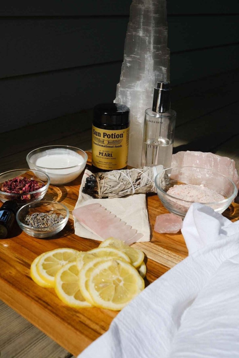 Sun Potion Pearl Powder jar on a cutting board with lemon slices, salt crystals and a white towel