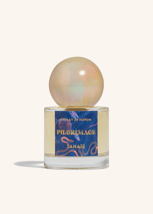 TANAÏS Pilgrimage Extrait de Parfum bottle with an opalescent pearl cap on a cream background