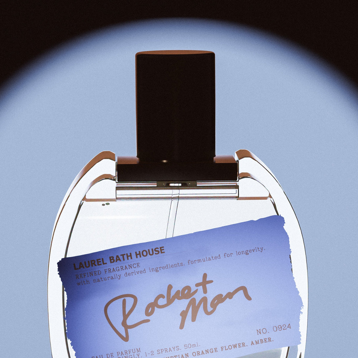 Close-up of the Laurel Bath House Rocket Man bottle and its blue torn paper label