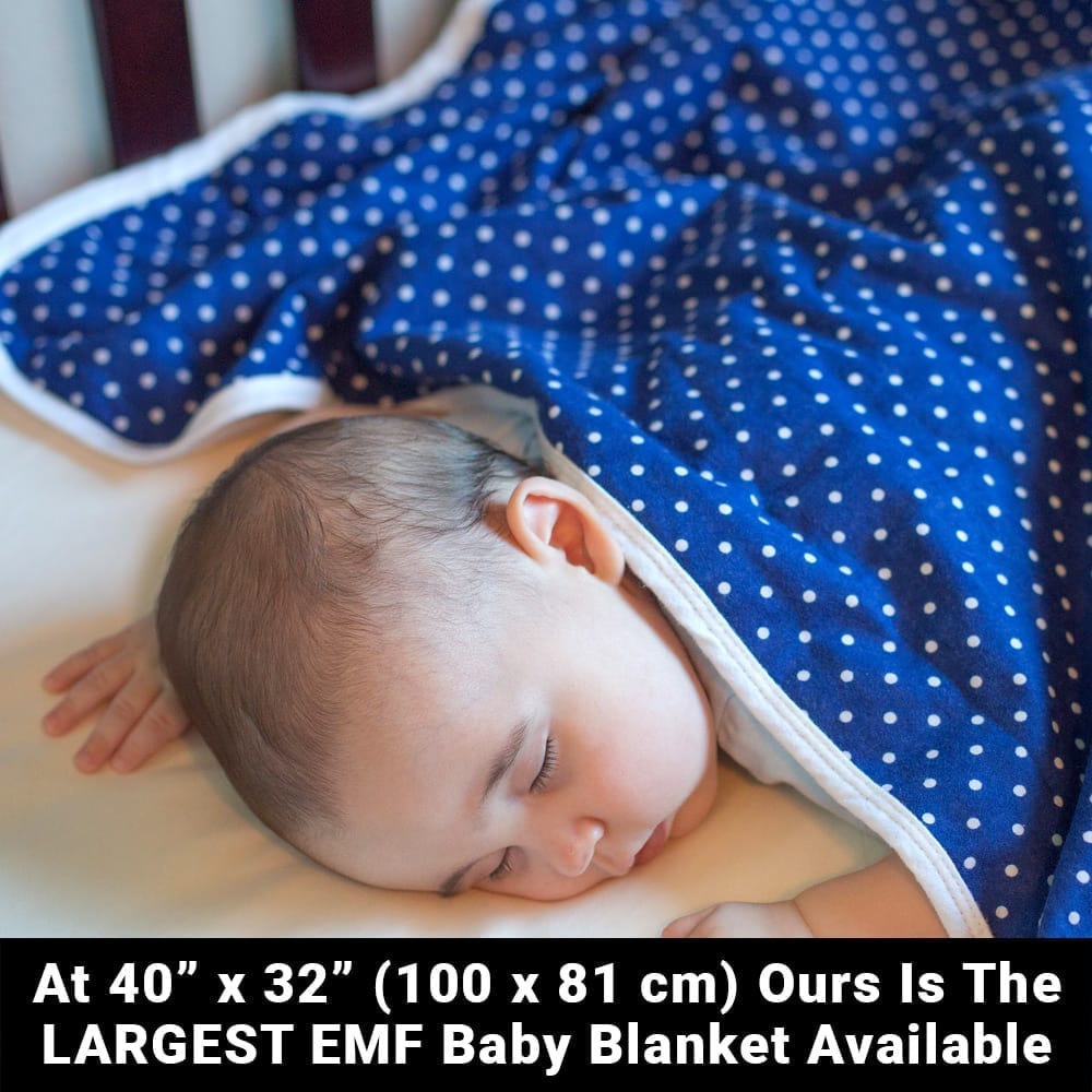 Baby sleeping on a blue polka dot Shield Your Body Baby Blanket: at 40 by 32 inches, the largest EMF baby blanket