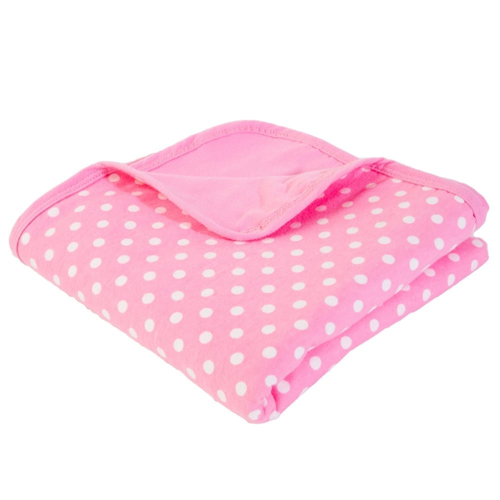 Shield Your Body Baby Blanket in pink polka dots folded over a pink trim