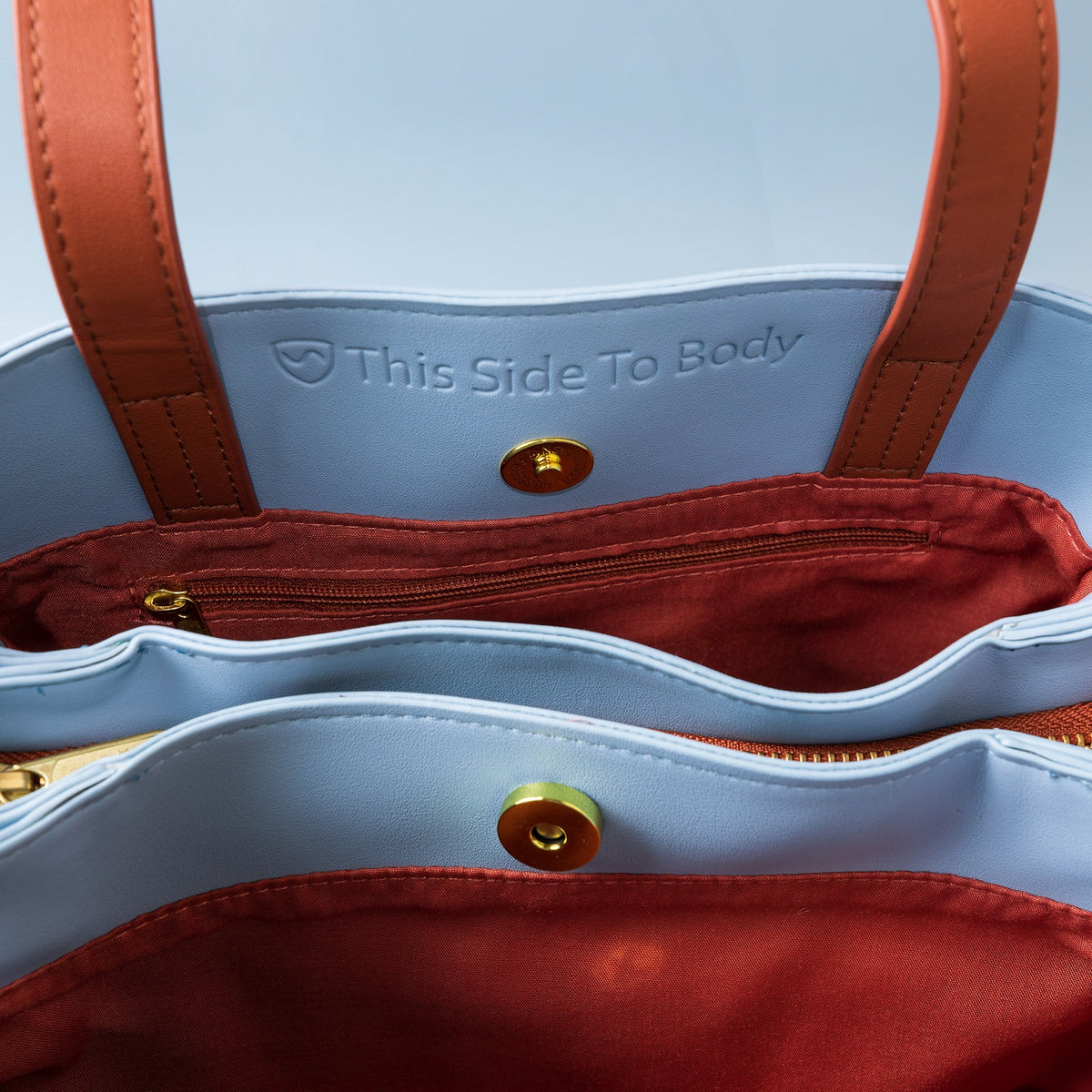 Inside of the Shield Your Body Purse: This Side To Body lining, snap closure and red interior