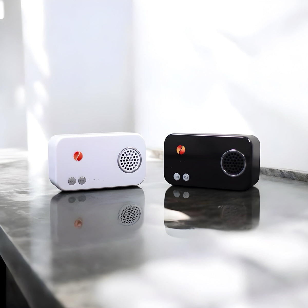 Therasage TheraO3 Ozone Modules, white and black, side by side on a marble countertop