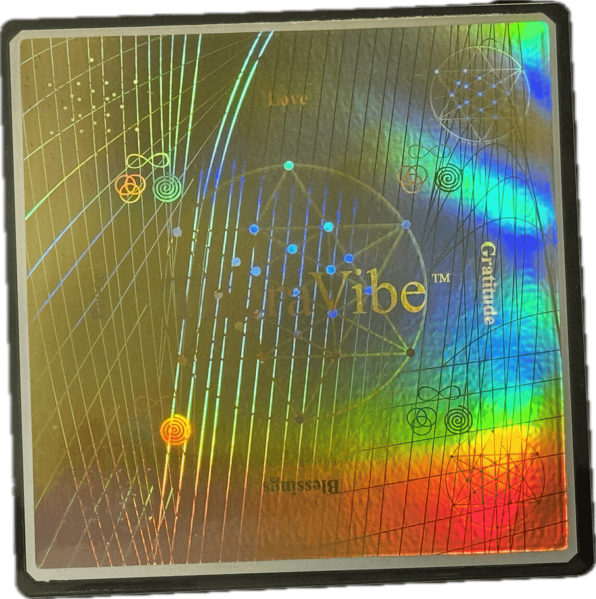 Close-up of a holographic Therasage TheraVibe Energy Card with rainbow reflections