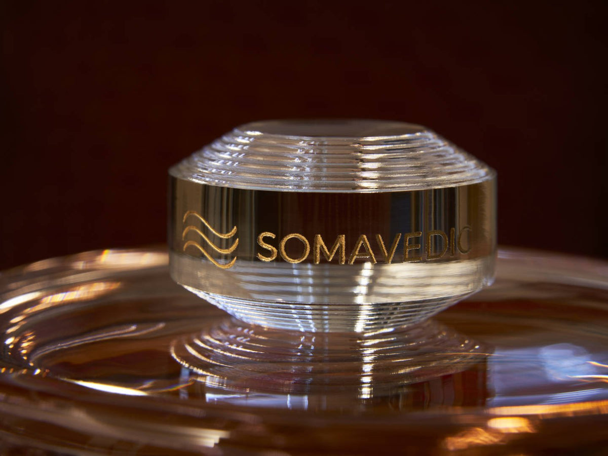 Somavedic Tiny clear glass resting on a glass dish