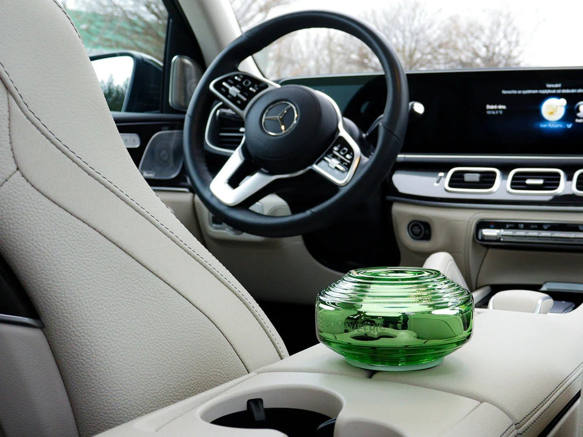 Somavedic Traveller on a car center console beside a cup holder