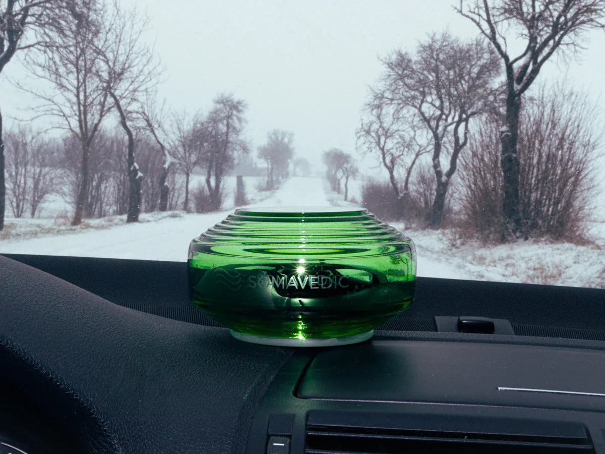 Somavedic Traveller on a car dashboard facing a snowy road